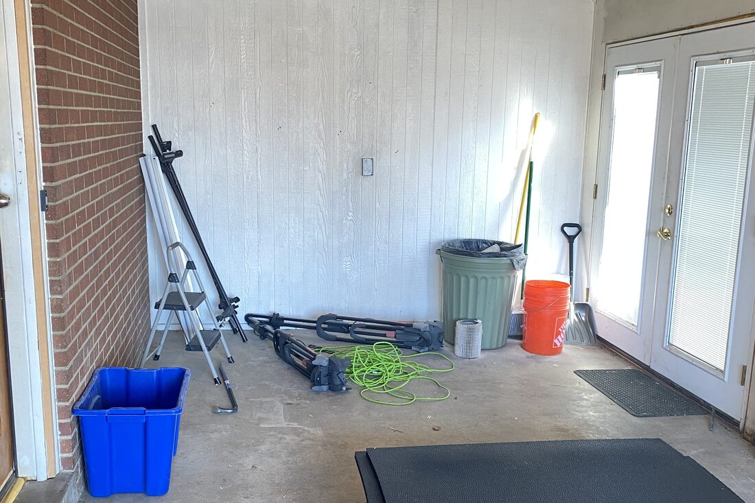 An empty one-car garage before the gym build