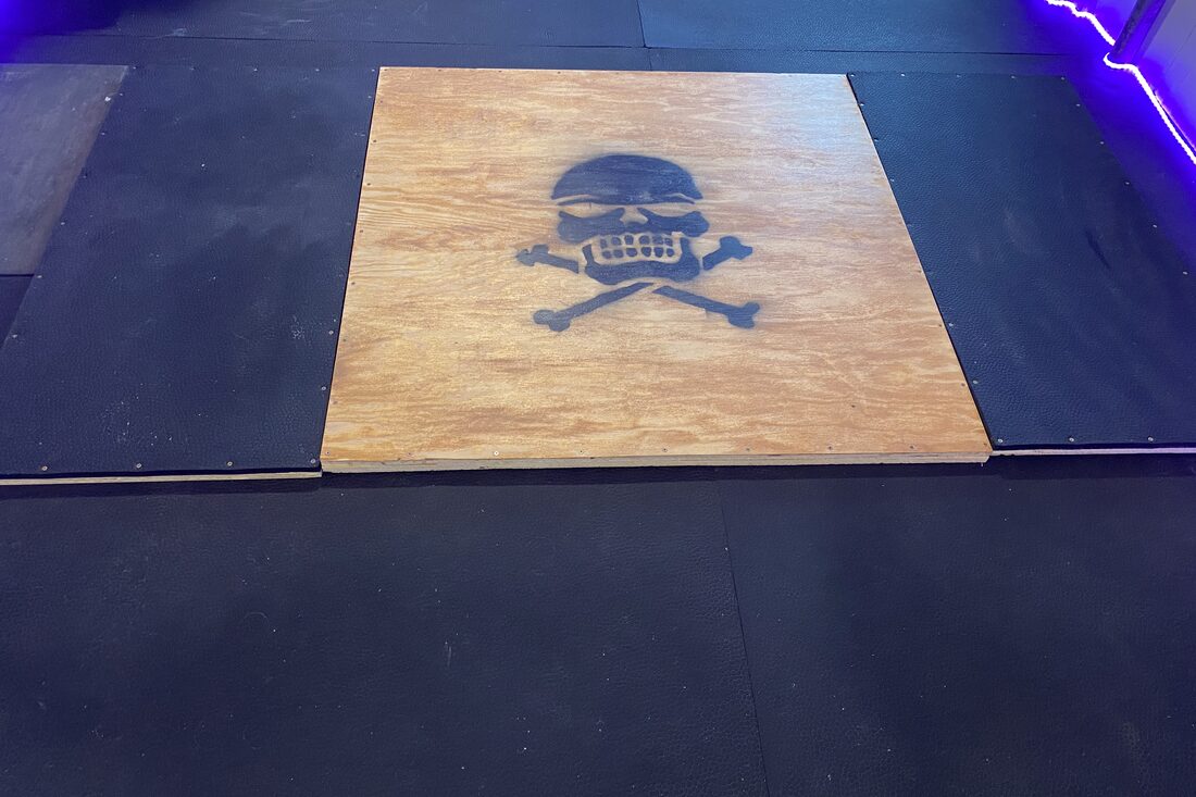 A hand-built deadlift platform with a skull stencil
